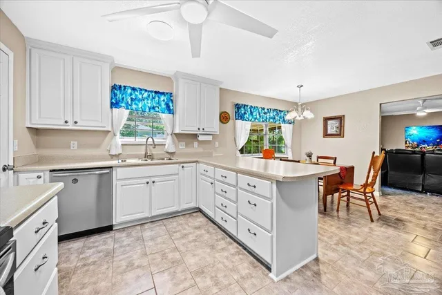 a kitchen with sink cabinets and chairs