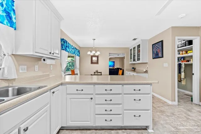 a kitchen with cabinets appliances and a sink