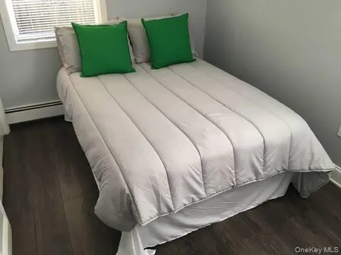a large bed sitting in a bedroom next to a window