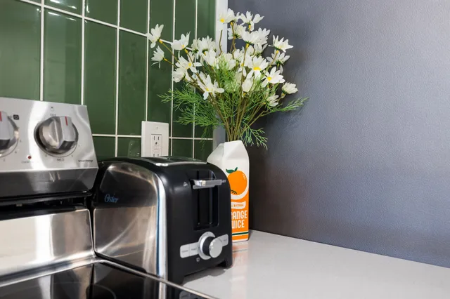 a kitchen with kitchen island a stove and a wooden floor