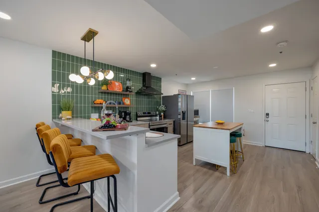 a view of a dining room with furniture wooden floor and chandelier