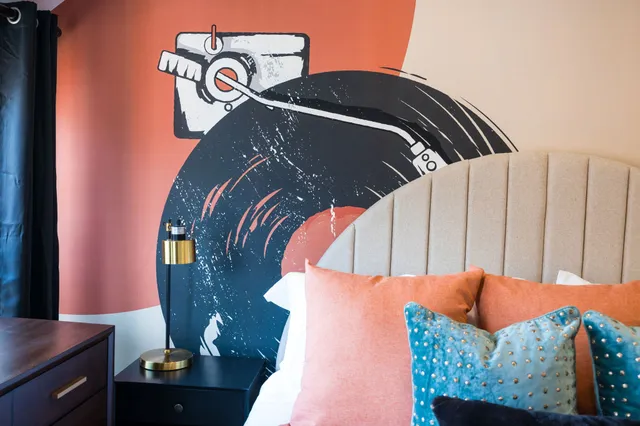 a bedroom with a bed and a large mirror