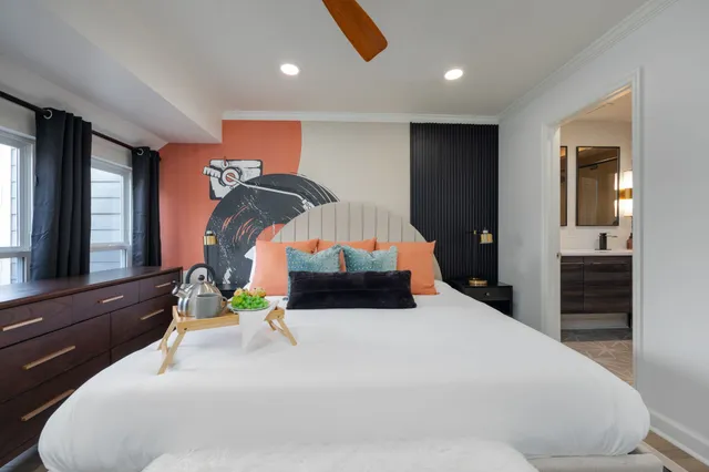 a bedroom with furniture and a large window