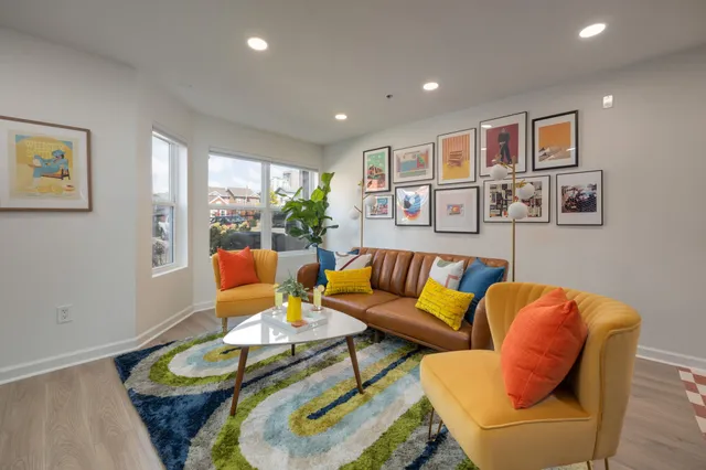 a living room with furniture ceiling fan and a window