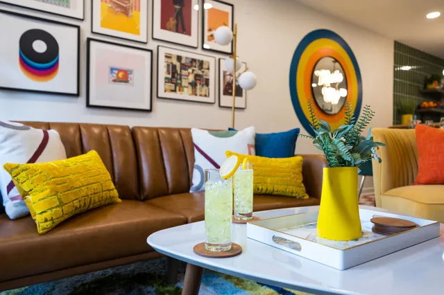a living room with chairs and a table
