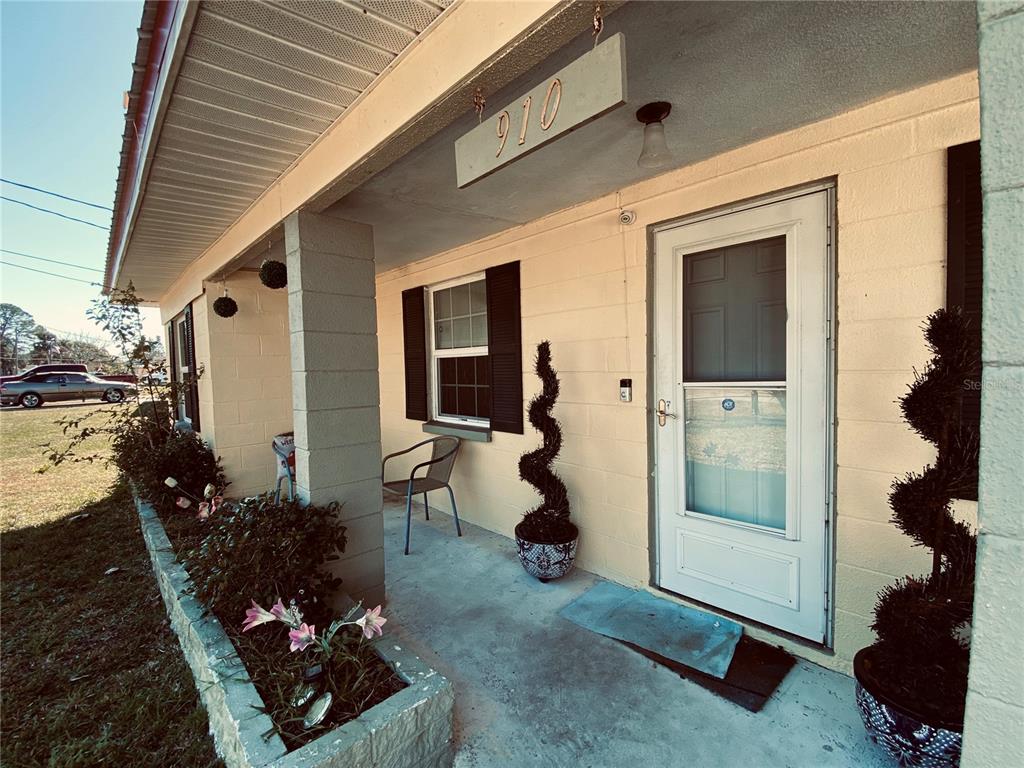 910 Lake Avenue Edgewater, FL 32132 - Photo 18 of 23 a front view of a house with garden