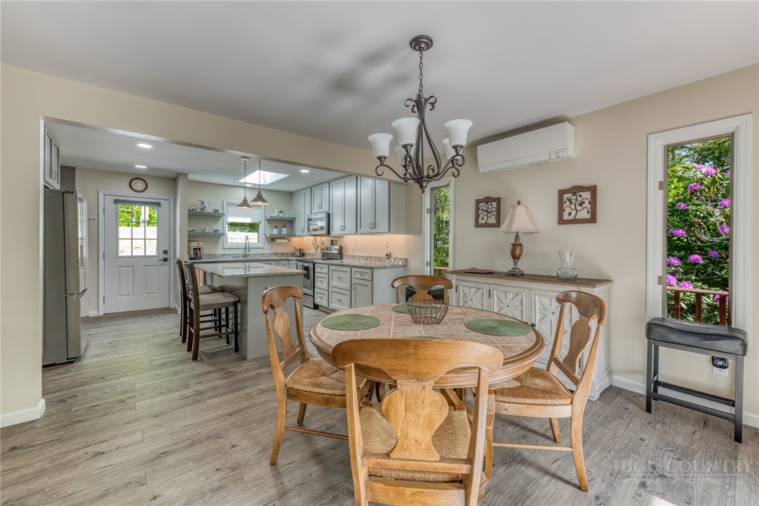 174 Spruce Pine Road Newland, NC 28657 - Photo 6 of 50 a view of a dining room with furniture and wooden floor