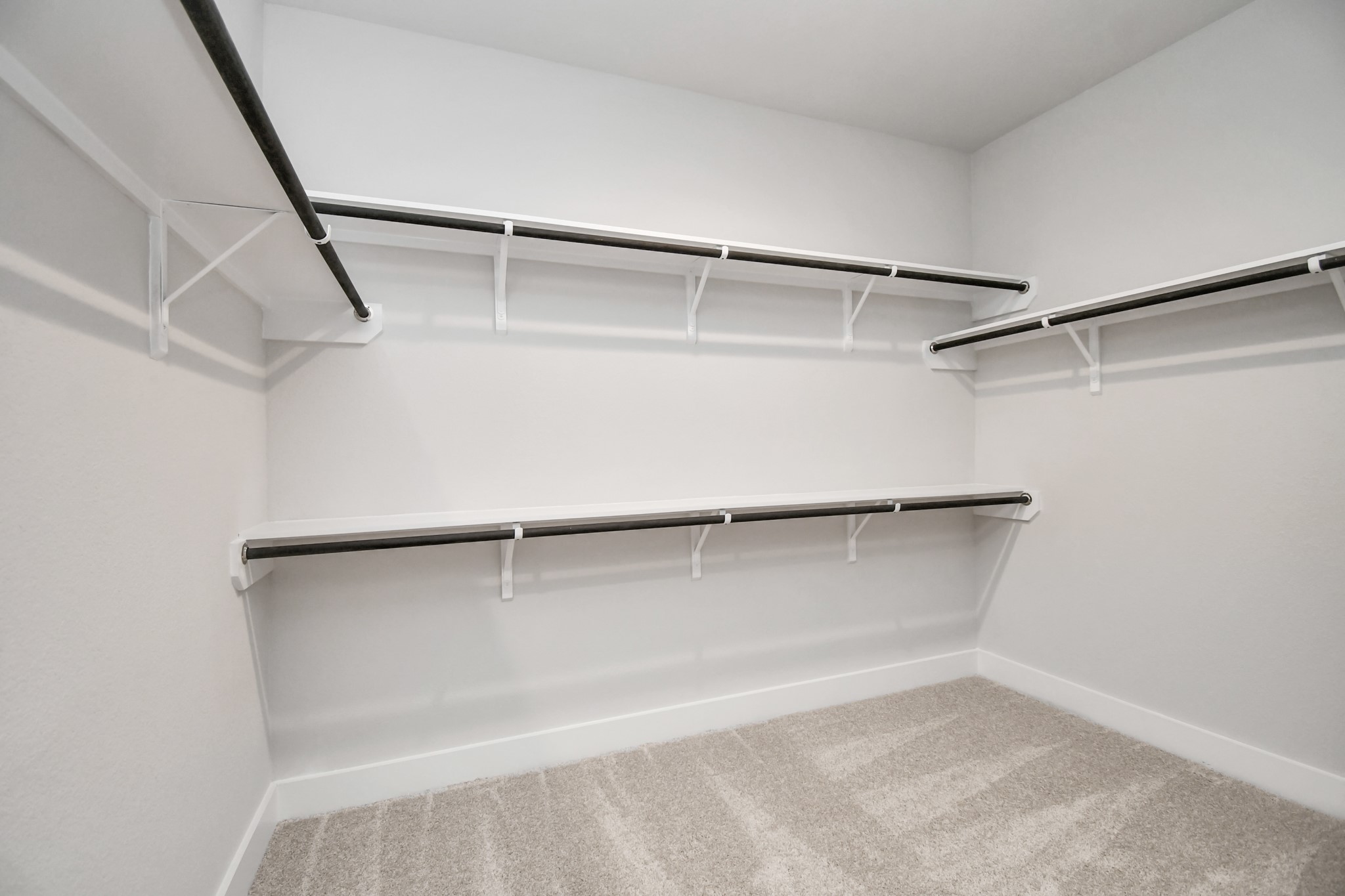 3038 Native Spg Drive Spring, TX 77373 - Photo 26 of 40 Walk-in closet that epitomizes luxury and practicality. This generously sized space features built-in shelving, offering abundant room for impeccable organization. High ceilings and recessed lighting create a bright and welcoming ambiance. Sample photo of completed home with similar floor plan. Actual colors and selections may vary.