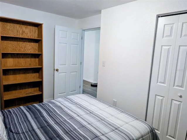 a bedroom with a bed and a walk in closet