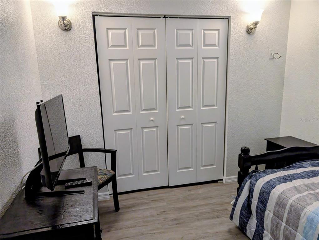 20422 Canvas Back Road Altoona, FL 32702 - Photo 18 of 24 a view of a bedroom with furniture and wooden floor