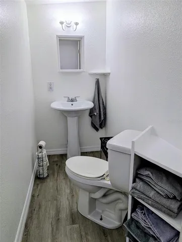 a bathroom with a sink toilet and a mirror