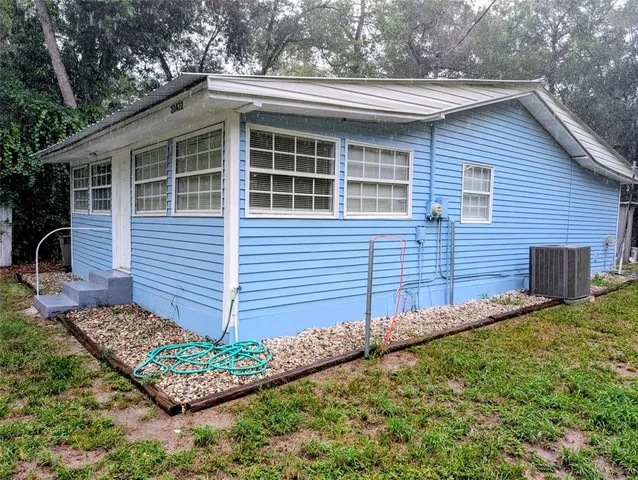 a view of house with backyard