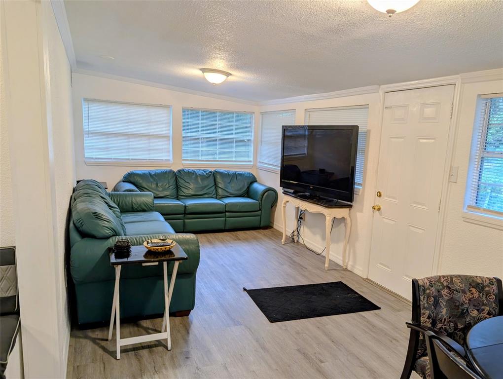 20422 Canvas Back Road Altoona, FL 32702 - Photo 8 of 24 a living room with furniture a flat screen tv and a window