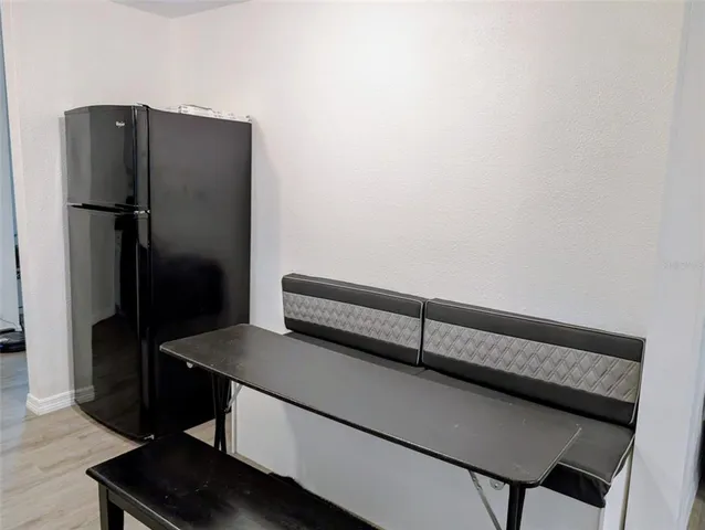 a kitchen with a refrigerator and a stove