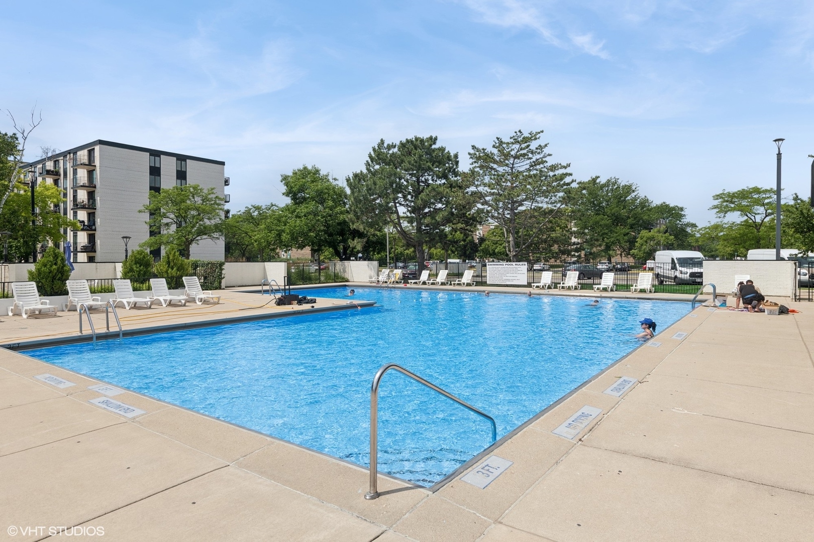 9701 North Dee Road, Unit 2I Niles, IL 60714 - Photo 20 of 24 a view of a swimming pool with outdoor seating and plants
