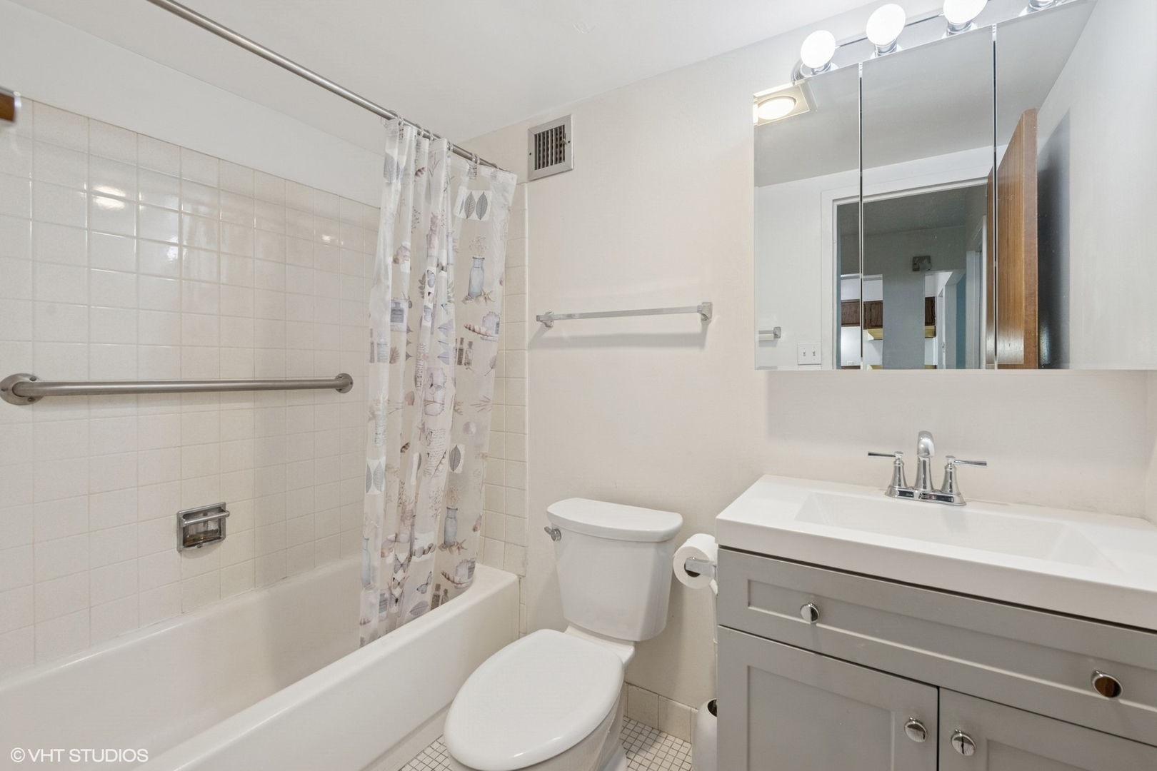 9701 North Dee Road, Unit 2I Niles, IL 60714 - Photo 10 of 24 a bathroom with a sink toilet a shower and a mirror