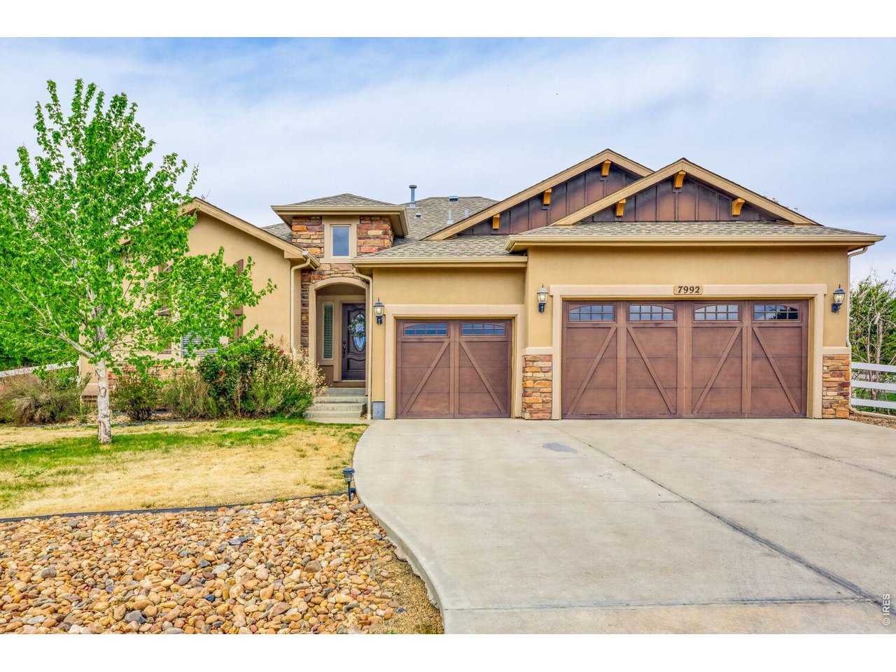 7992 St Street Frederick, CO 80530 - Photo 27 of 28 a front view of a house with a yard and garage