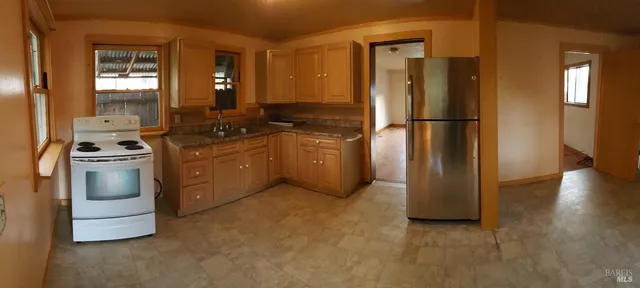 a kitchen with a refrigerator sink and stove