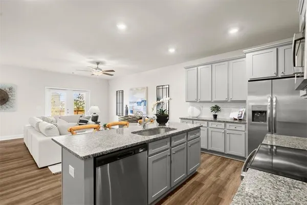 a kitchen with a sink stove and refrigerator