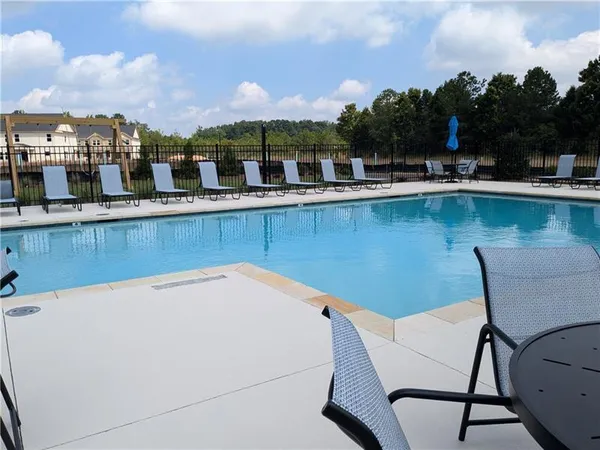 a view of a swimming pool with outdoor seating