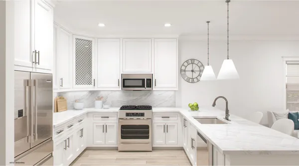 a kitchen with stainless steel appliances granite countertop a stove a sink and a refrigerator