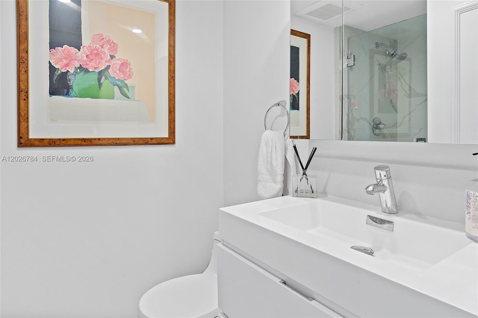 151 Southeast 15th Road, Unit 601 Miami, FL 33129 - Photo 30 of 36 a bathroom with a sink vanity and mirror