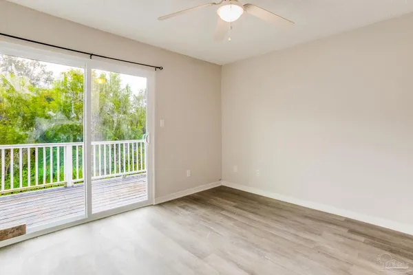 a view of a room with wooden floor and a window
