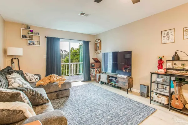 a bedroom with furniture and a flat screen tv