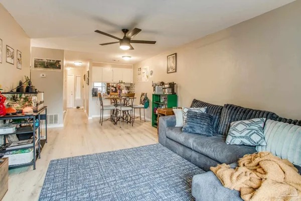a living room with furniture and a chandelier