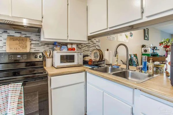 a kitchen with stainless steel appliances granite countertop a sink and cabinets
