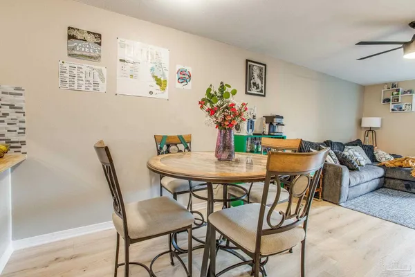 a dining room with furniture and wooden floor