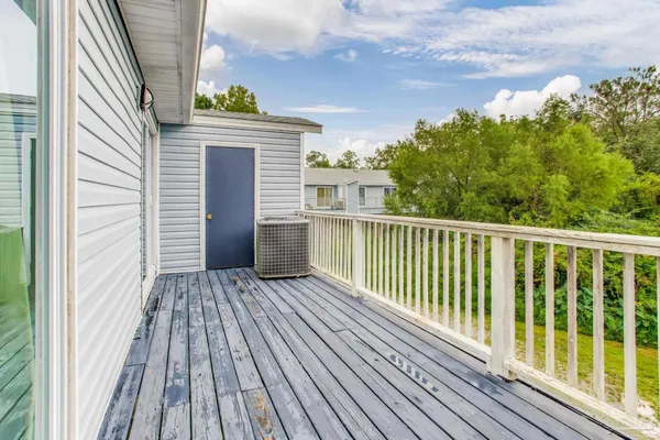 a view of a wooden deck with a yard