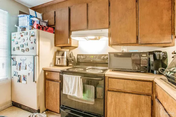 a kitchen with stainless steel appliances granite countertop a sink and a refrigerator