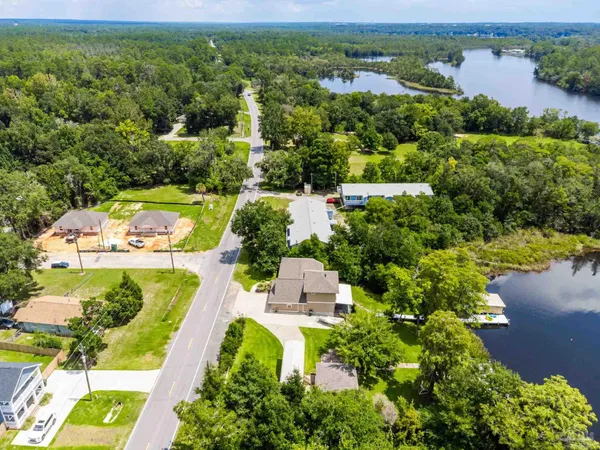 an aerial view of residential houses with outdoor space and street view