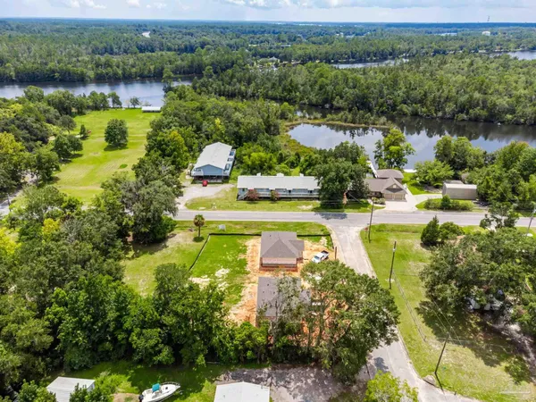 an aerial view of residential houses with lake view