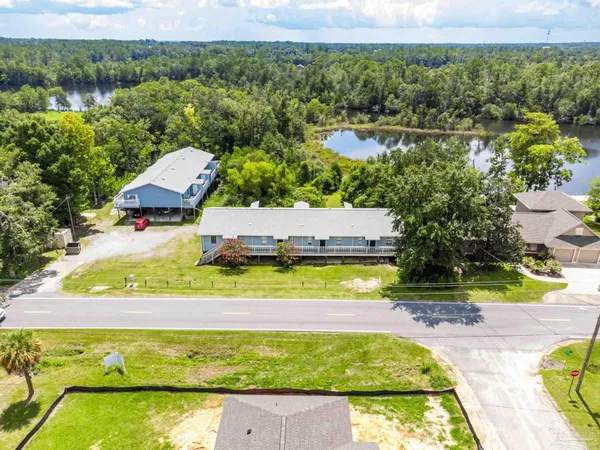 an aerial view of residential houses with outdoor space and swimming pool