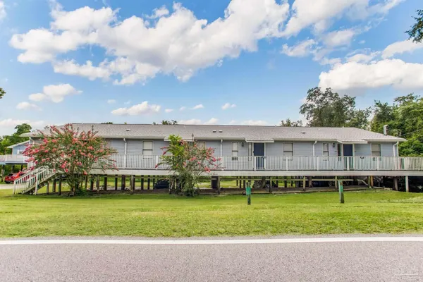 a view of a house with a yard and sitting area