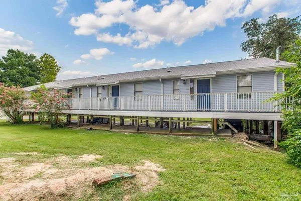 a view of a house with pool and a yard