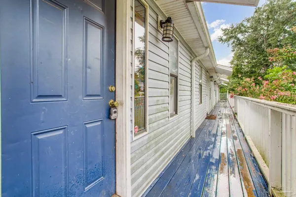 a view of balcony with wooden floor