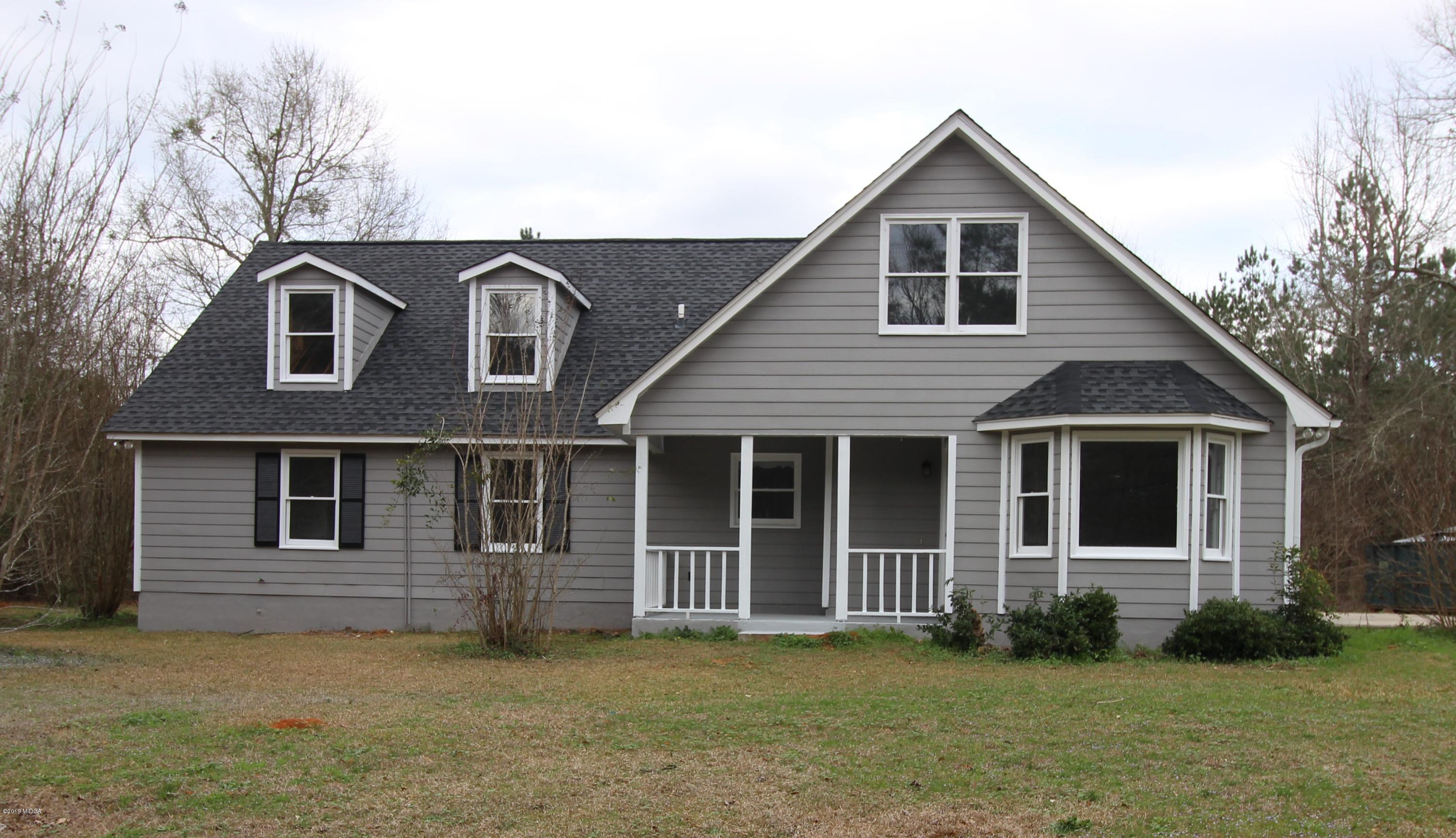 922 Woolfolk Road Fort Valley, GA 31030 - Photo 1 of 38 a front view of a house with a garden