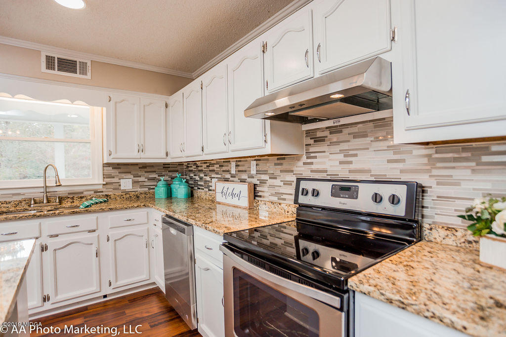 922 Woolfolk Road Fort Valley, GA 31030 - Photo 12 of 38 a kitchen with white cabinets and appliances