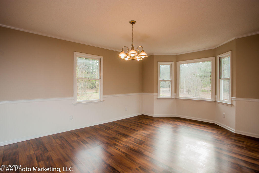 922 Woolfolk Road Fort Valley, GA 31030 - Photo 14 of 38 a view of a room with wooden floor and windows
