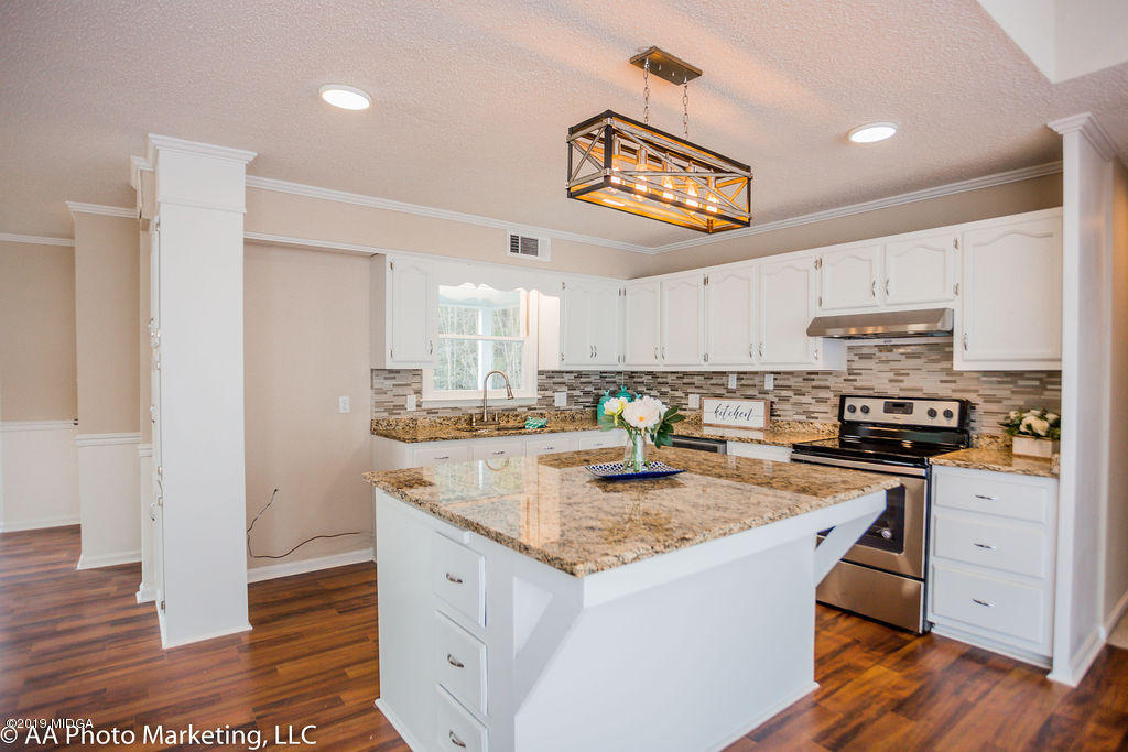 922 Woolfolk Road Fort Valley, GA 31030 - Photo 3 of 38 a kitchen with stainless steel appliances granite countertop a sink stove and refrigerator