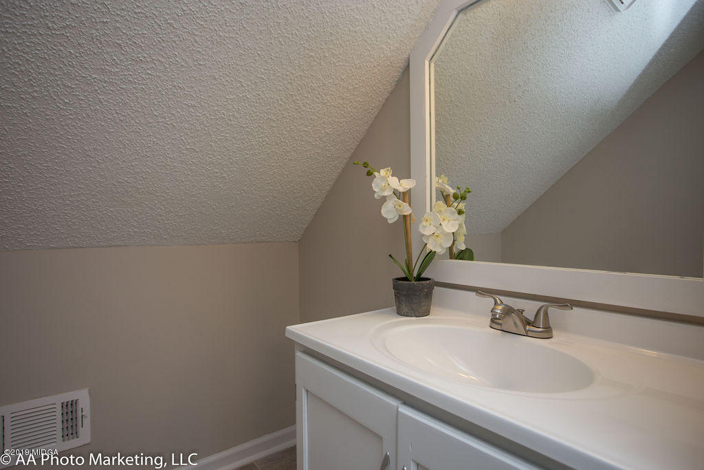 922 Woolfolk Road Fort Valley, GA 31030 - Photo 21 of 38 a bathroom with a sink and a mirror