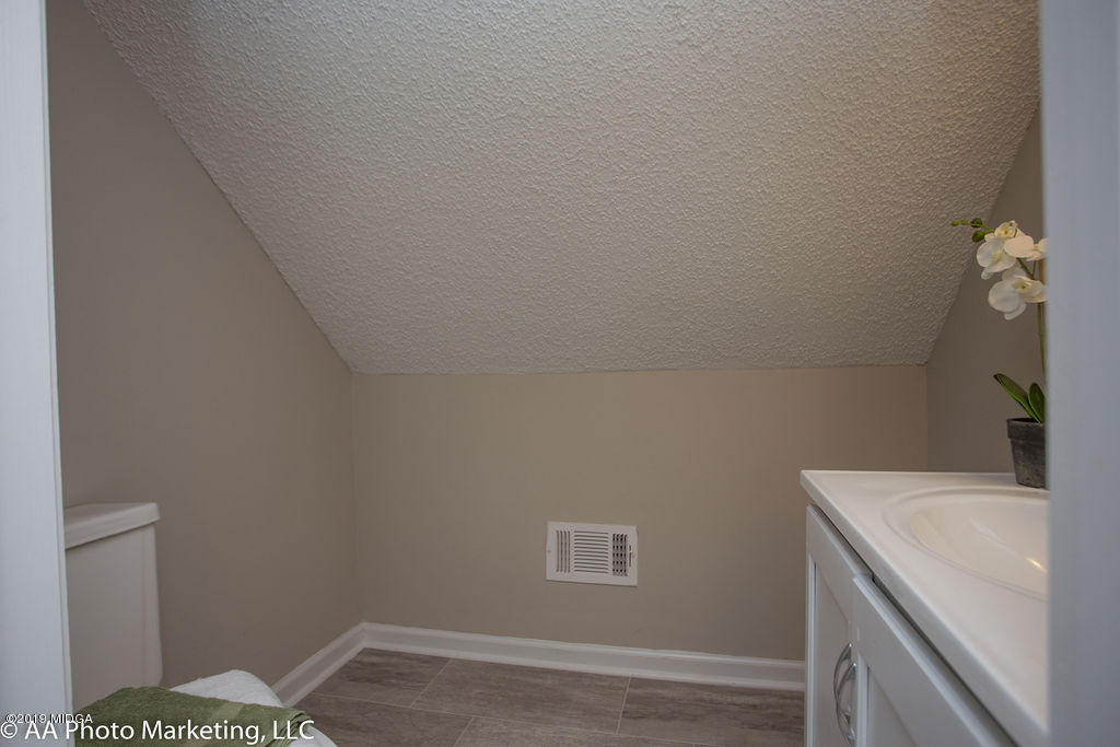 922 Woolfolk Road Fort Valley, GA 31030 - Photo 22 of 38 a bathroom with a sink and vanity