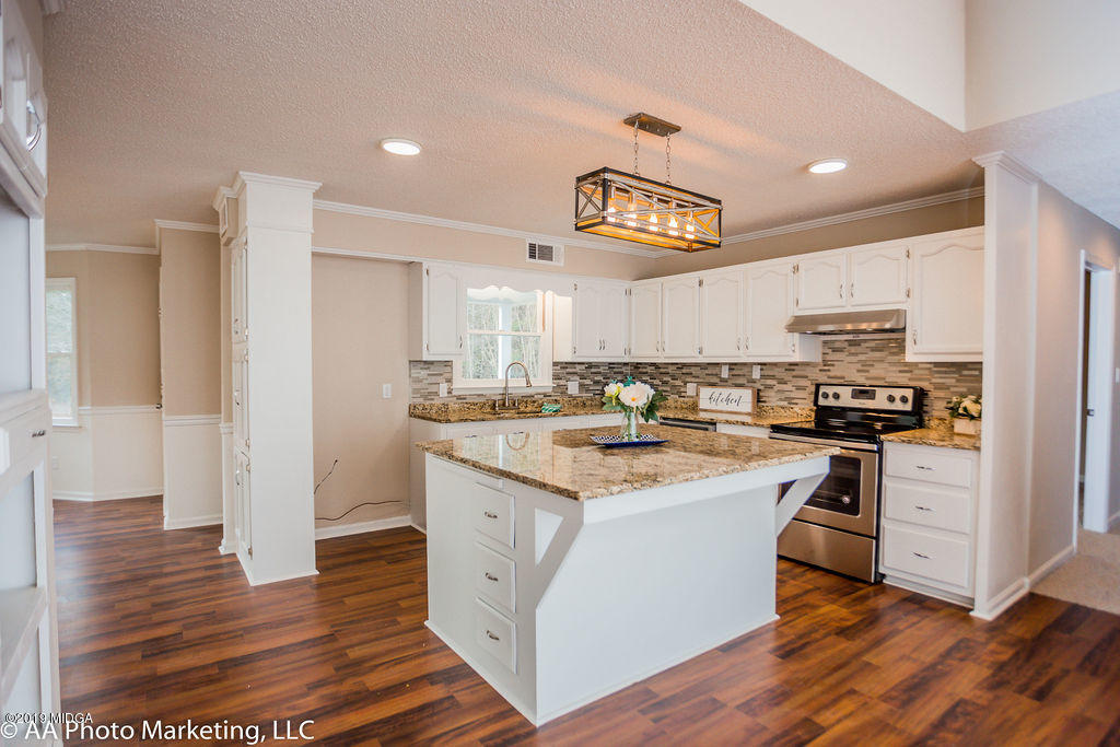 922 Woolfolk Road Fort Valley, GA 31030 - Photo 4 of 38 a kitchen with stainless steel appliances granite countertop a stove and a refrigerator