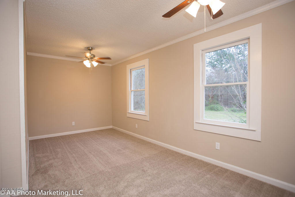 922 Woolfolk Road Fort Valley, GA 31030 - Photo 31 of 38 an empty room with windows and fan