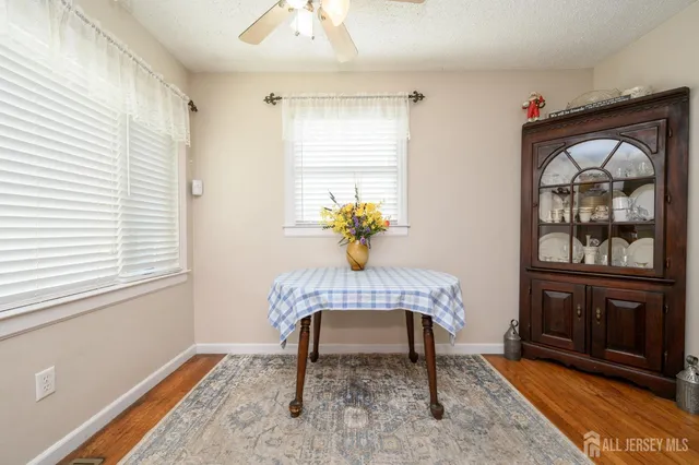 a dining room with furniture and window