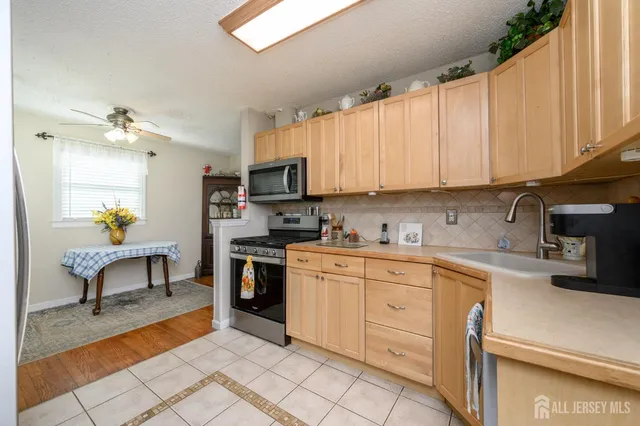 a kitchen with a sink cabinets and window