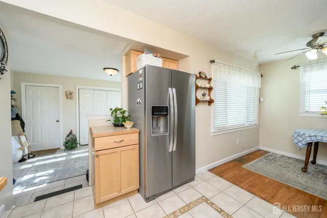 a kitchen with a refrigerator and cabinets